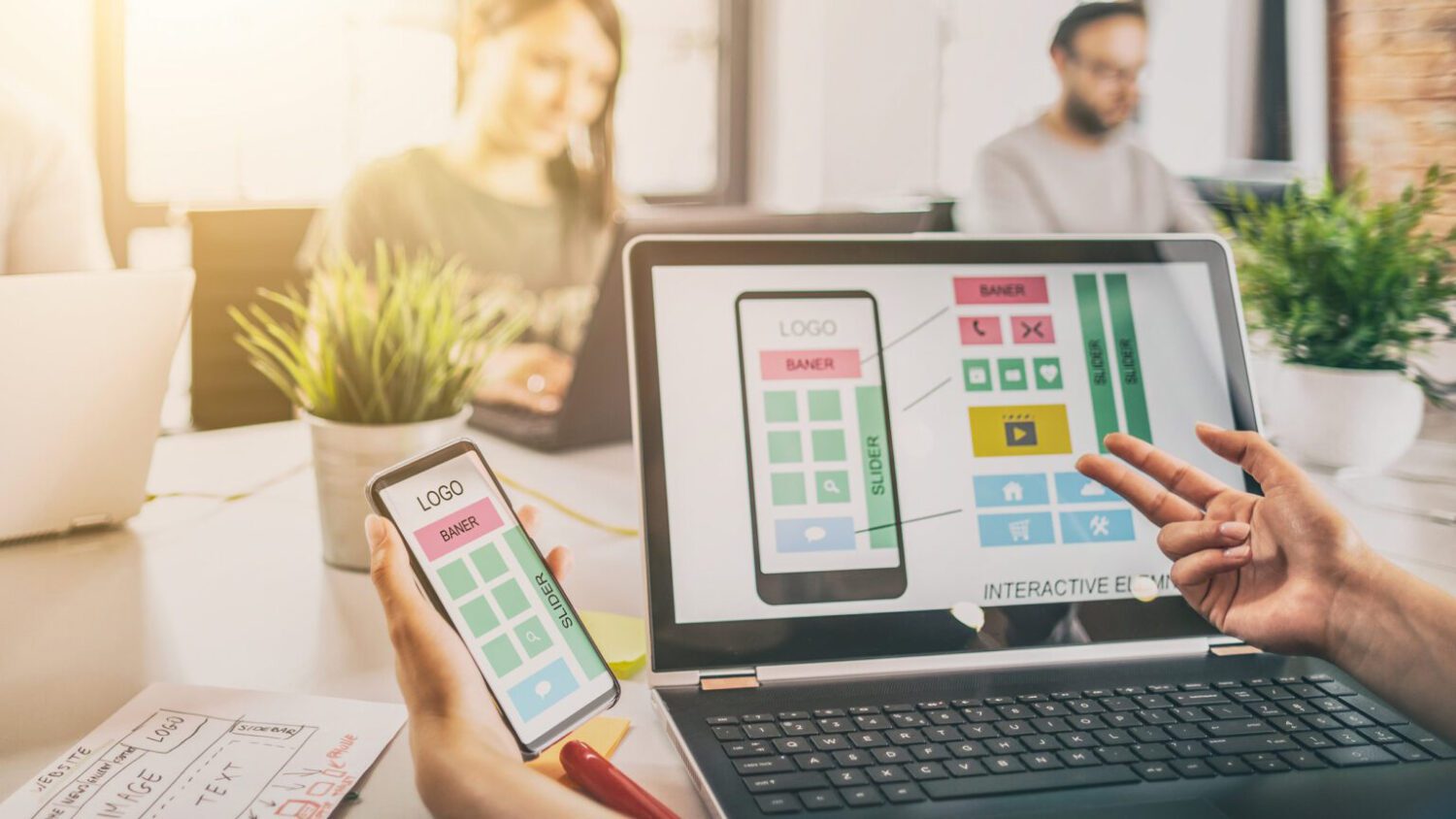 Designers drawing website ux app development.